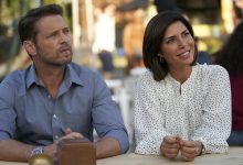 Jason Priestley as Matt Shade and Cindy Sampson as Angie Everett on Private Eyes sitting at a desk